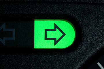 Green turn arrow on car dashboard. Right