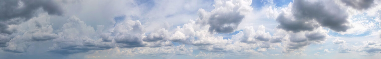 The panorama of the dark gray clouds contrasted with the blue sky was both dramatic and beautiful, Sky background.