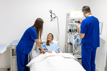 Wall Mural - Hospital Ward: Friendly Doctor and nurse taking care of Beautiful Caucasian Female Patient Resting in Bed. Physician explains Test Results. Woman Recovering after Successful Surgery