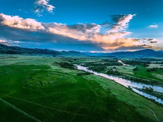 Canvas Print - Aerial view of the Paradise Valley and Yellowstone River with gorgeous clouds above at sunset