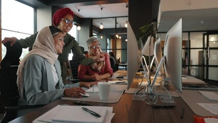 Wall Mural - Creativity and collaboration in a coworking office as female colleagues work on a marketing campaign