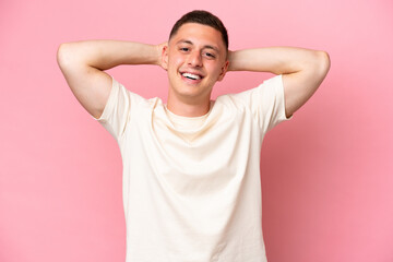 Wall Mural - Young Brazilian man isolated on pink background laughing