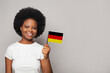 © millaf (Nemchinova) - German woman holding flag of Germany Education, business, citizenship and patriotism concept