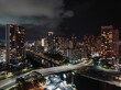 Drone long exposure view of Waikiki bridge with the city's modern architectures illuminated at night