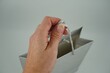 Closeup of a woman's hand taking a gift box on a white background