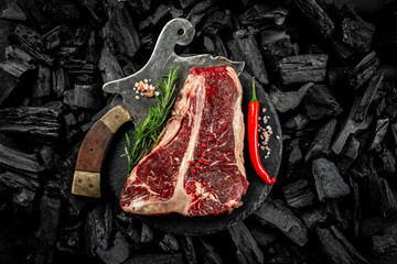 marbled beef T-bone or porterhouse beef meat Steak on BBQ grill coal. Fresh meat for grilling. steak raw striploin of beef. top view. place for text