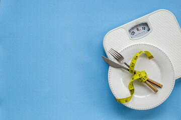 Wall Mural - Weight scale and tape measure on dinner plate. Dieting and weight control concept