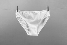 White Washed Women's Panties Made Of Cotton With Clothespins Hanging On A Rope Black And White Photo