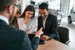 © standret - Man is buying automobile for his girlfriend. Three people are working together in the car showroom