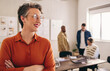 © Jacob Lund - Happy mature businesswoman smiling while standing in an office