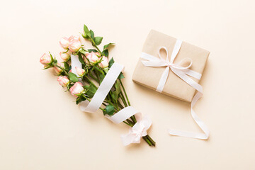 Wall Mural - design concept with pink rose flower and gift box on colored table background top view. Happy Holiday, Mothers day, birthday concept. Romantic flat lay composition