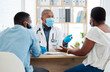 © Nina/peopleimages.com - Covid, health and doctor consulting a black couple in a hospital for wellness, insurance or treatment. Medical, healthcare or trust with a medicine professional talking to a man and woman in a clinic