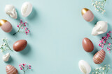Fototapeta Mapy - Happy Easter double border frame made of Easter eggs, bunnies, flowers on pastel blue background. Easter holiday greeting card template.