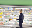 © lado2016 - supermarket shopping,Woman choosing a dairy products at supermarket.