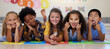 © Nina Lawrenson/peopleimages.com - Kids, floor and group portrait with funny face in school classroom, solidarity or diversity in childhood. Girl, boy and children in class, academy and happy multicultural friends, together or playful