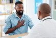 © Nina Lawrenson/peopleimages.com - Doctor, patient and consulting in healthcare checkup, illness or appointment at the hospital. Black man talking to medical professional about chest pain, consultation or health problems at clinic