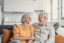 Happy Laughing Older Married Couple Talking, Laughing, Standing In Home Interior Together, Hugging With Love, Enjoying Close Relationships, Trust, Support, Care, Feeling Joy, Tenderness.