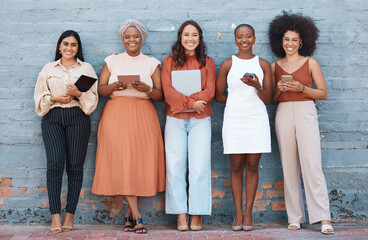 Canvas Print - Portrait, group and business women smile on brick wall with devices or gadgets in city. Technology, cooperation and teamwork, diversity or collaboration of friends, people or employees with happiness