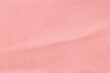 The Light pink fabric background from a textile material.
