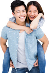 Portrait of happy man giving piggyback ride to woman