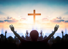 Easter And Good Friday Concept,  Soft Focus Of Christian Worship With Raised Hand On Cross Sunset Background