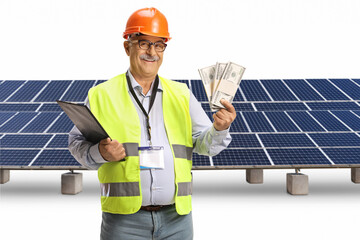 Wall Mural - Happy male engineer with a safety vest and hardhat holding stacks of money