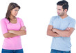 Angry couple standing arms crossed on white background