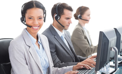 Canvas Print - Business people with headsets using computers 