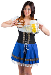 Wall Mural - Pretty oktoberfest girl holding beer tankard and pretzel