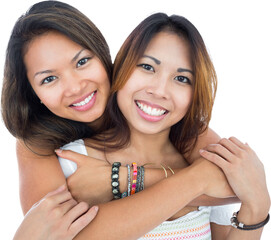 Wall Mural - Two pretty sisters posing in front of the camera