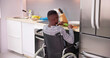 © Andrey Popov - Young Disabled Man Sitting On Wheel Chair Preparing Food