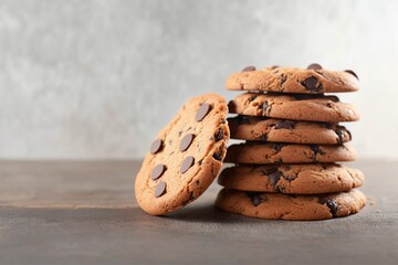 chocolate chip cookies, stack of chocolate chip cookies on a wooden table, chocolate chip cookies on a white wooden table