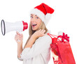 Festive blonde holding megaphone and bags