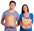 Young couple holding grocery bags