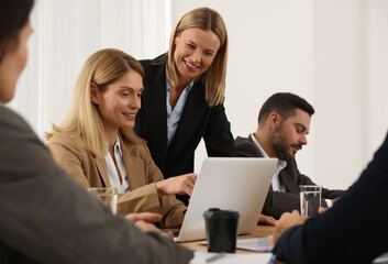 Canvas Print - Businesswoman having meeting with her employees in office