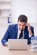 © Elnur - Young male employee and too much work in the office