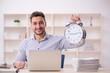 © Elnur - Young male employee in time management concept