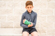 © 3Days2Go Media - Young preteen boy athlete with arm cast sitting on bench outside