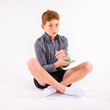 © 3Days2Go Media - Young boy with his arm in a cast sitting cross legged on the floor with a worried expression