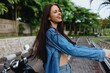 © SHOTPRIME STUDIO - Portrait of a woman brunette smile with teeth walking outside against a backdrop of palm trees in the tropics, summer vacations and outdoor recreation, the carefree lifestyle of a freelance student.