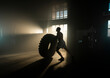© Videophilia - Muscular shirtless man cross training with tractor tyre at the gym. Athlete flipping tyre