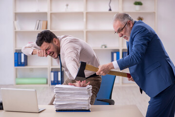 Canvas Print - Old male boss and young male employee in bullying concept