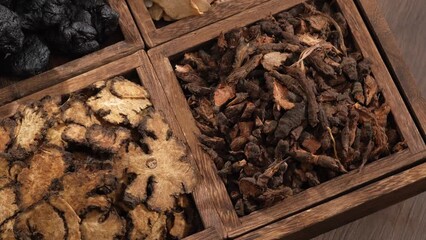 Canvas Print - Four types of herb contained inside a square wooden tray with four compartments spinning around. Close-up view. Chinese herbal therapy