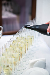 Stylish champagne glasses and food appetizers on table at wedding reception