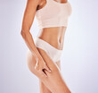 © Malik/peopleimages.com - Health, liposuction and legs of woman in studio for weight loss, wellness and exercise on white background. Skincare, fitness and girl pinch leg in underwear for workout, diet routine and slim figure