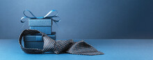 Happy Fathers Day Background Banner. Two Blue Gift Boxes With Ribbon Bow And Necktie On Dark Blue Table. Monochrome. Gift Delivery For Him. Male Fashion