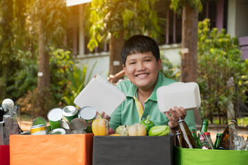 Asian boy in caucasian is separating garbage with his friend at the park, soft and selective focus, environment care, community service and summer vacation activities of teenagers concept.