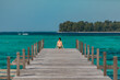 © Piotr - Girl sitting at the and of jetty at amazing turquoise lagoon with on Karimunjava tropical island, Indonesia