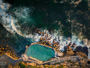 aerial drone view of bronte ocean pool in sydney during sunrise in soft early morning light, new sou