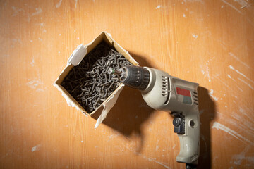 Wall Mural - Drill with screws on the table.